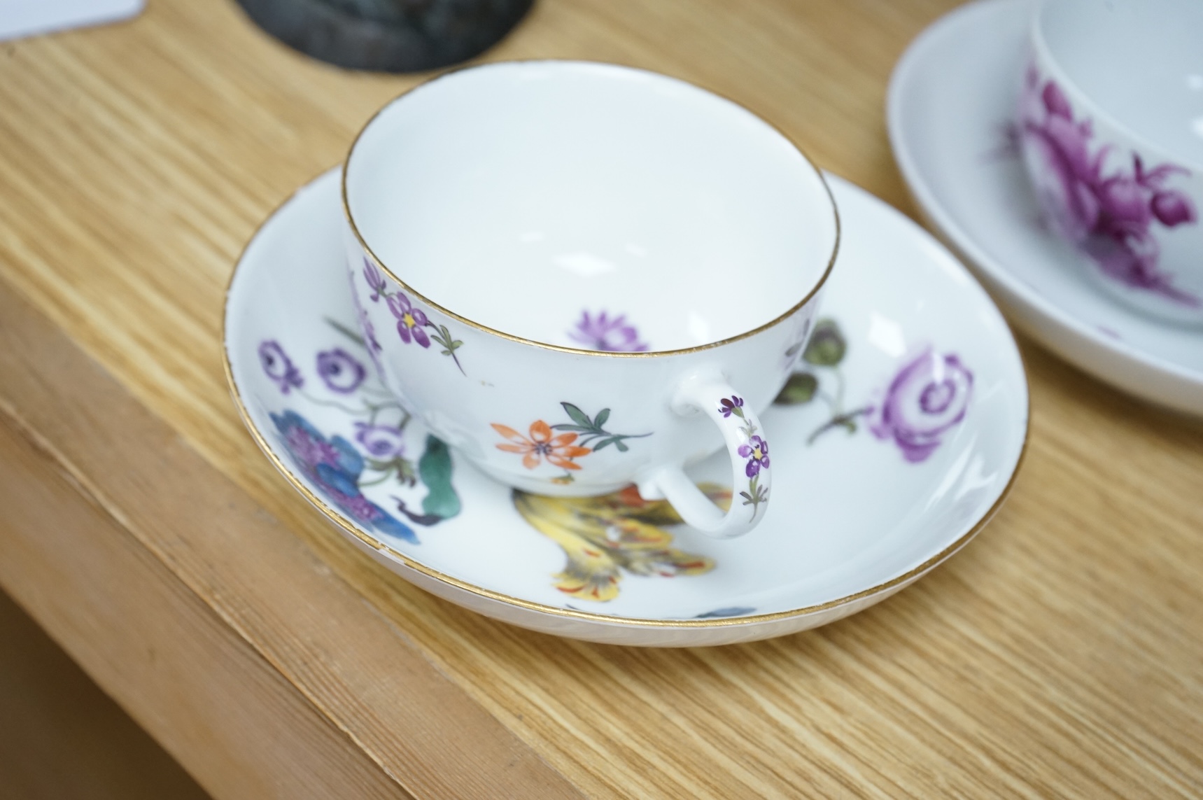 Two 18th century Meissen floral decorated teacups and saucers, largest saucer 13.5cm diameter